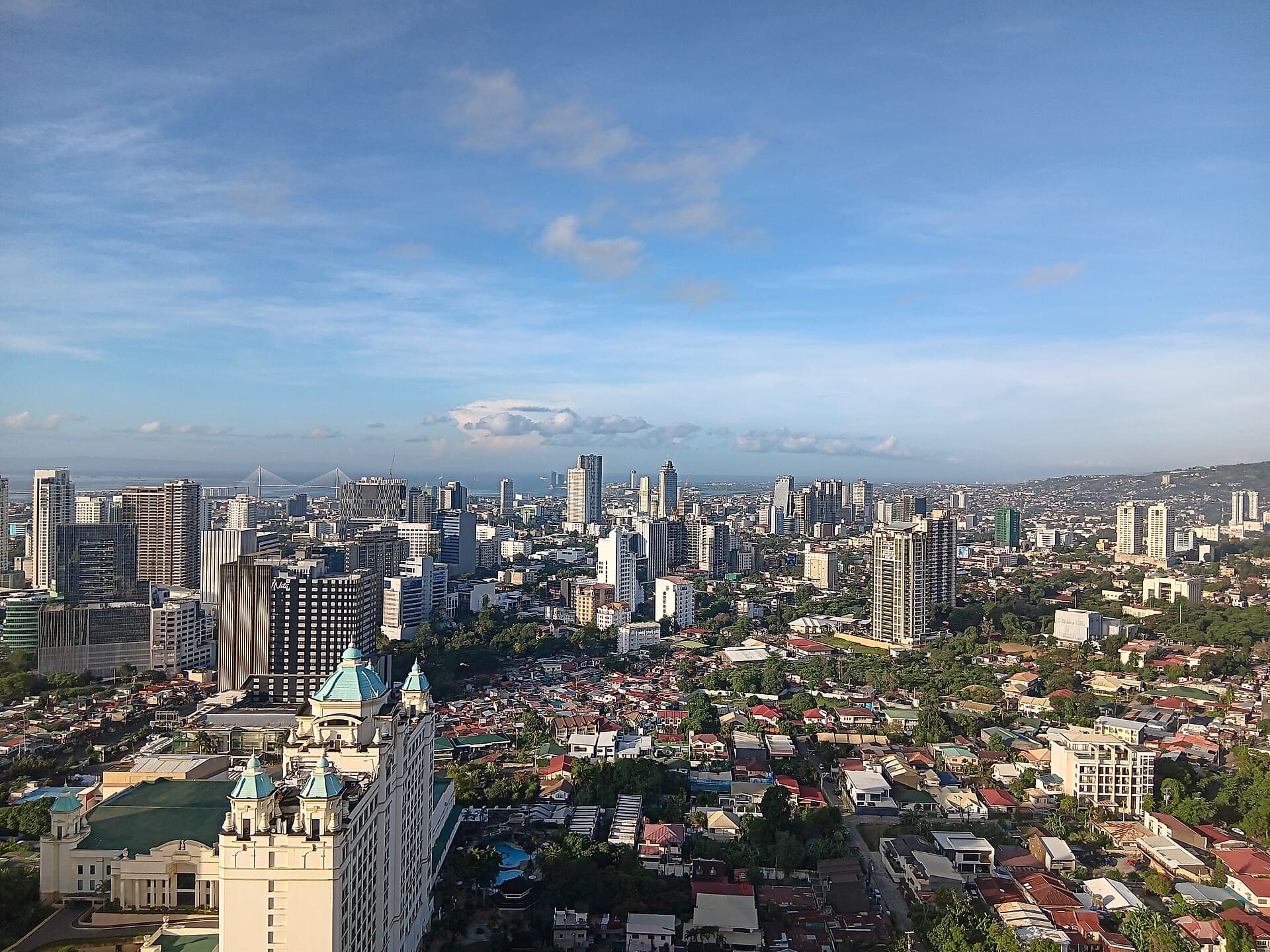 Cebu City skyline with high-rises and the Cebu–Cordova bridge across the water