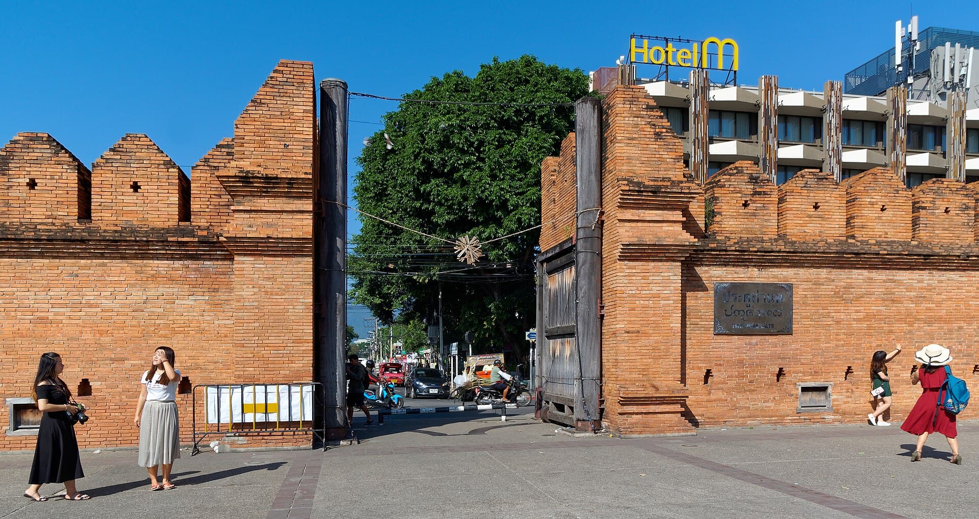 Tha Phae Gate in Chiang Mai, brick city wall and a songthaew through the opening