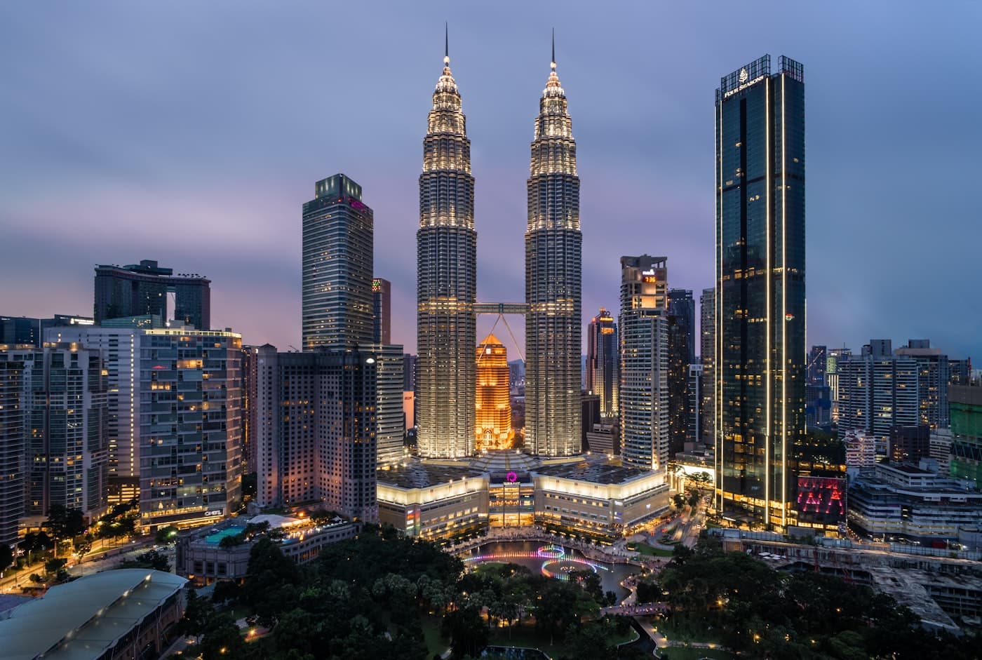 Petronas Twin Towers and KLCC Park at dusk in Kuala Lumpur