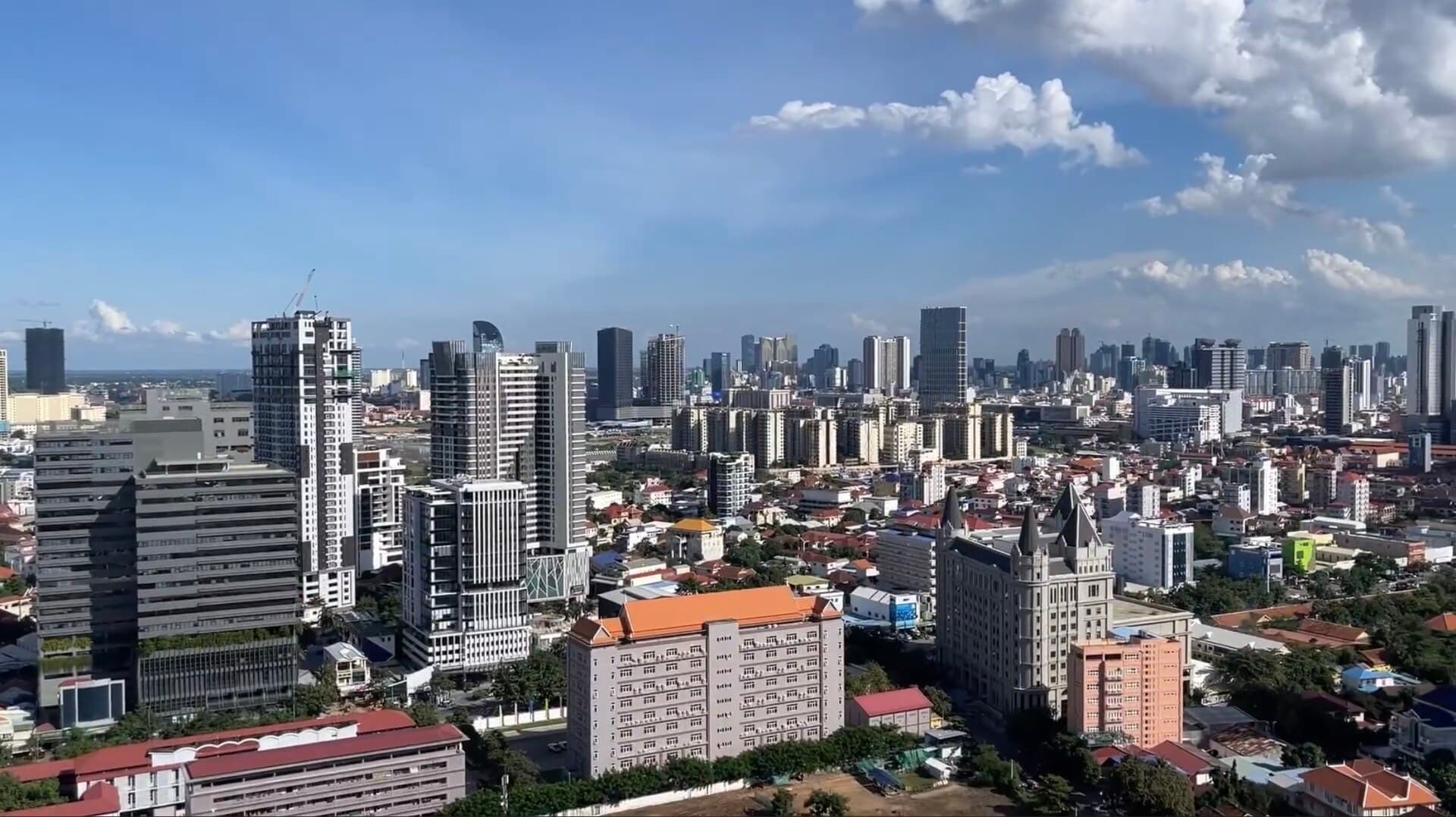 Phnom Penh skyline, mix of towers and terracotta roofs under a clear sky